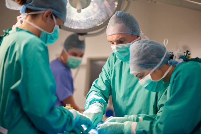 <p>Anaesthetists performing an operation </p>