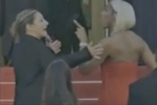 <p>An unidentified female security guard, went viral last week for her interactions with celebrities at the Cannes Film Festival. She is pictured left with singer Kelly Rowland </p>