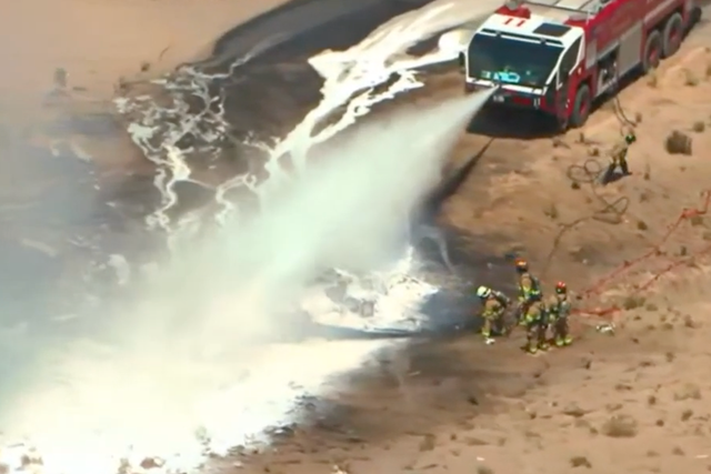 <p>Fire crews attend the scene at an airport in New Mexico, after a military aircraft crashed</p>